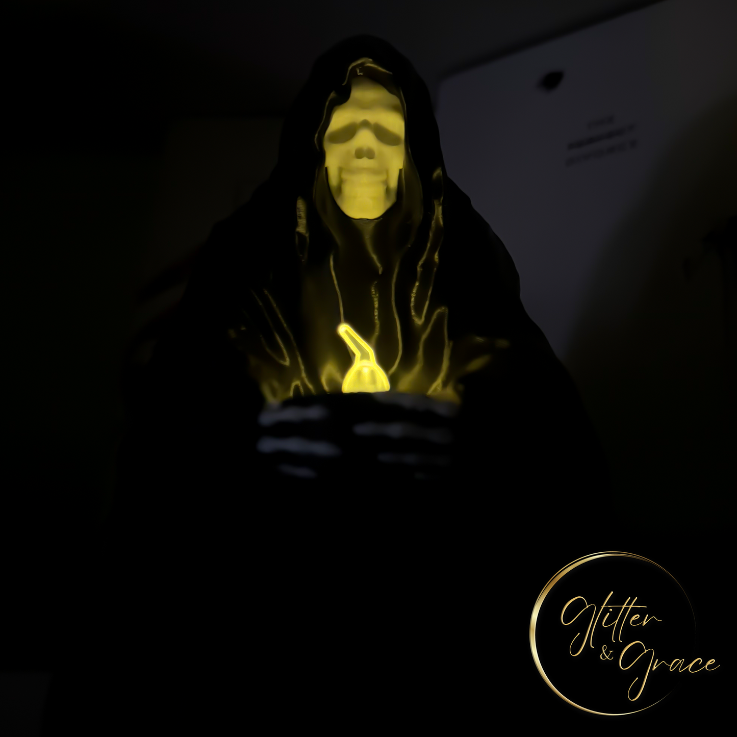 3d printed statue of a sitting grim reaper holding a led tealight candle