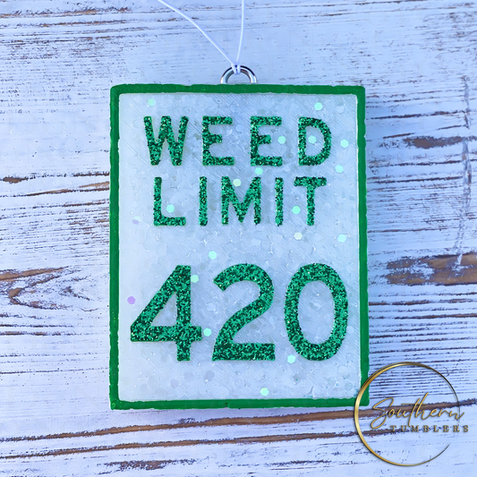 car air freshener saying weed limit 420 in white with green glitter