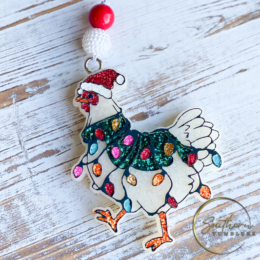 car air freshener in the shape of a chicken decorated with holiday lights wearing a santa hat