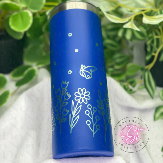20oz skinny powder coated tumbler in blue laser engraved with florals and butterflies all the way around the tumbler