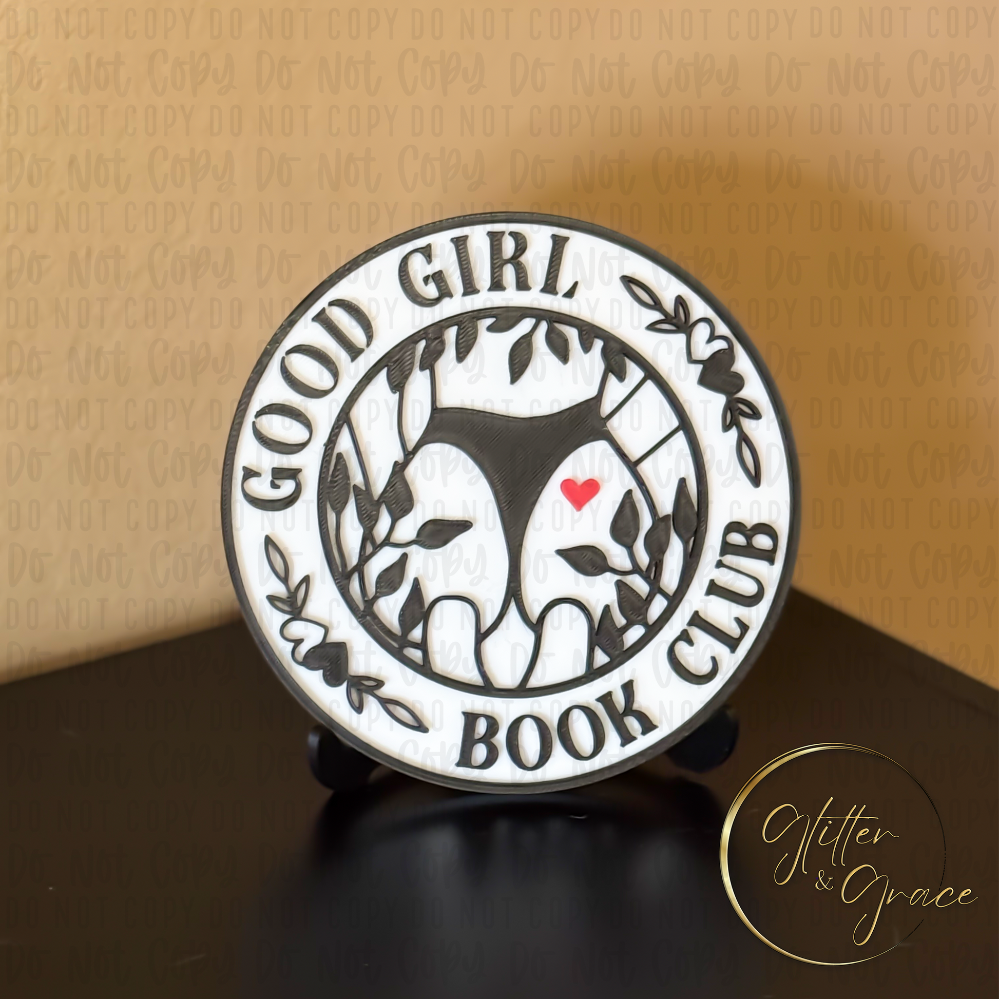 3d printed book shelf sign saying good girl book club with the image of a lady in a thong and a heart on her behind