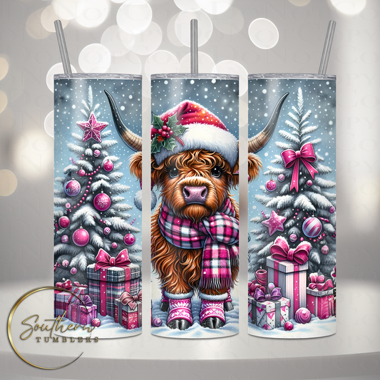 20oz stainless steel tumbler cup decorated with a adorable highland cow wearing a santa hat standing next to evergreen trees and presents in a snowing field