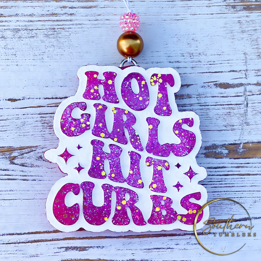 car air freshener saying got girls hit curbs in pink with gold glitter and a white background