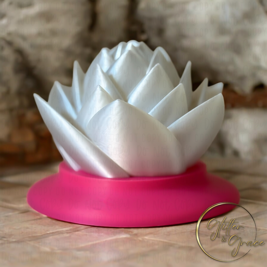3d printed lotus flower sitting on a base that hides the LED tealight candle illuminating the flower