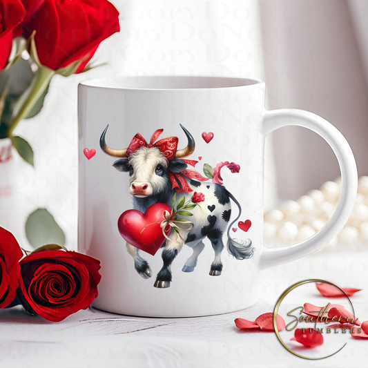 11oz coffee or tea mug decorated with a sublimated design of a cow surrounded by hearts