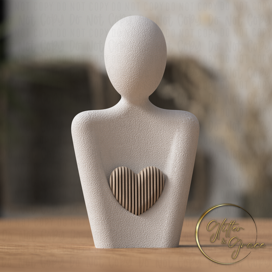 3d printed statue of a mother with a heart above the arms