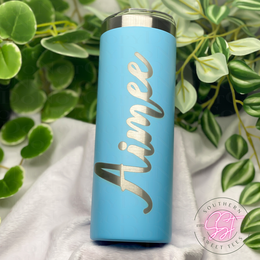 20oz skinny powder coated sky blue colored tumbler laser engraved with a personalized name