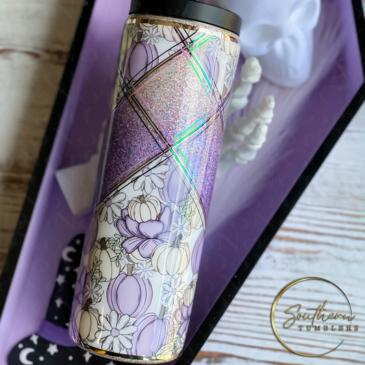 20oz skinny duo tumbler decorated with purple and beige glitter wrapped with purple and beige pumpkins and white with purple daisies stripped to finish
