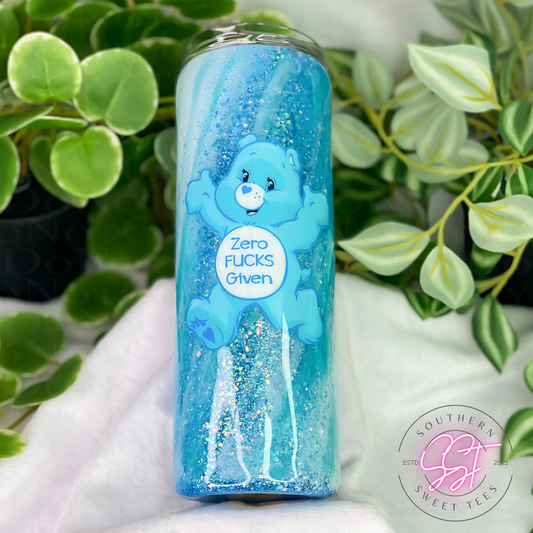 20oz skinny straight tumbler designed with shades of blue and white glitter with a milky way effect and a swear bear decal saying zero fucks given
