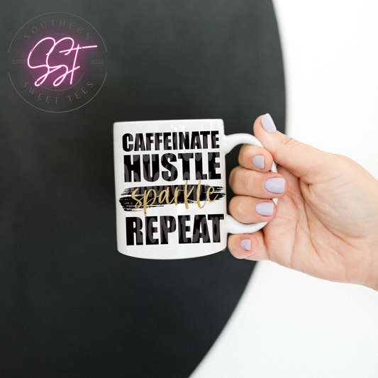 11oz drinking mug saying caffeniated hustle sparkle repeat in black ink however sparkle is in gold sparkling ink