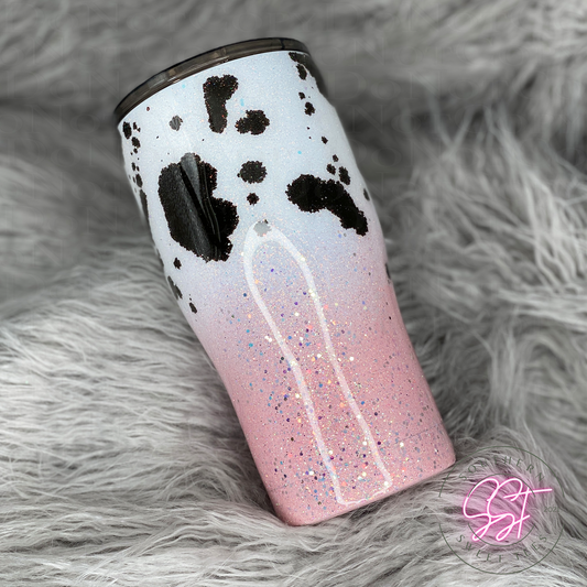 20oz modern curved tumbler decorated with white and pink ombre glitter and black alcohol ink cow print spots 