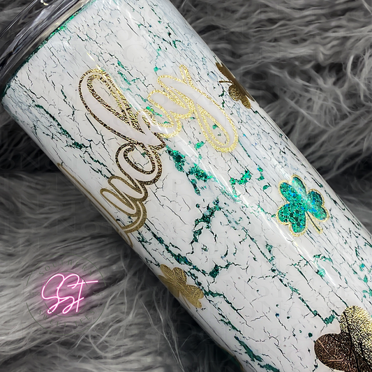 30oz skinny tumbler cup distressed look with a peekaboo into the green glitters below with images of clovers saying lucky